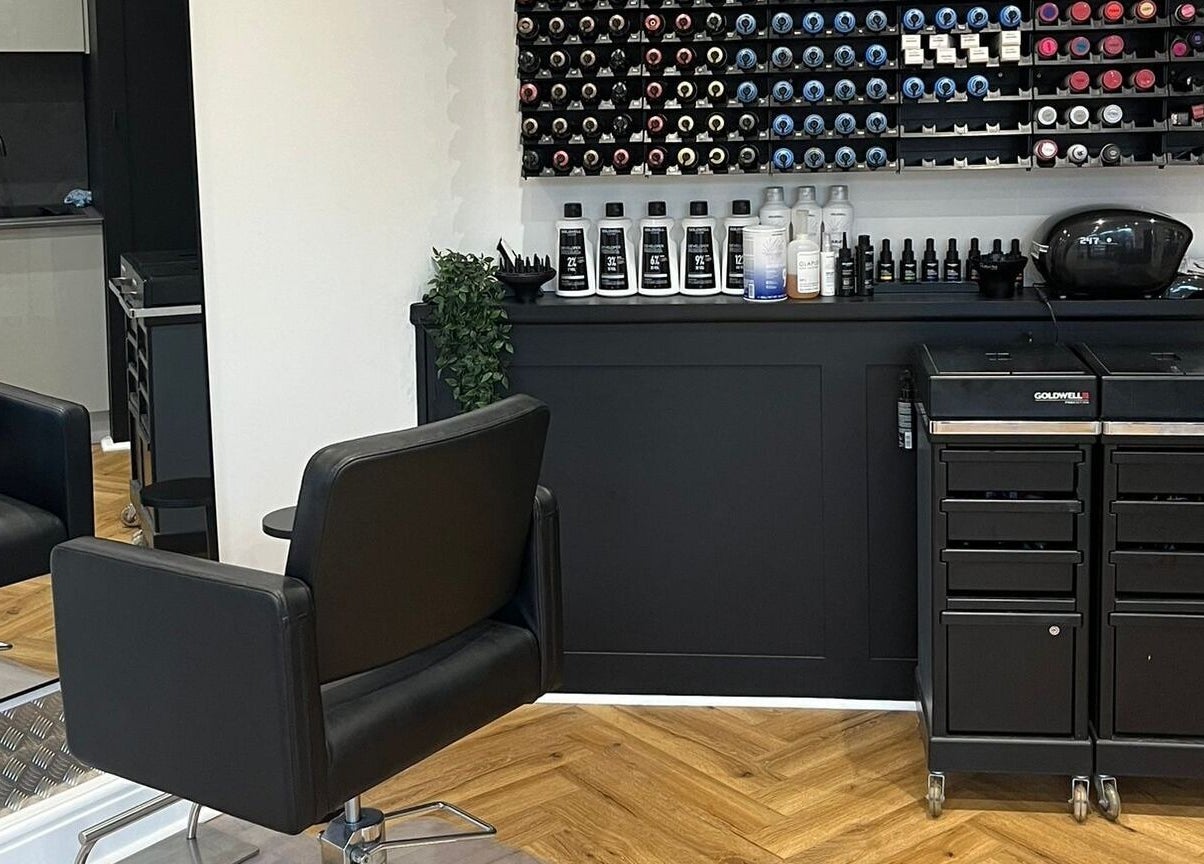 Modern salon interior at Andrew David Hair, Lymington, England, GB, featuring styling chairs and hair color display.