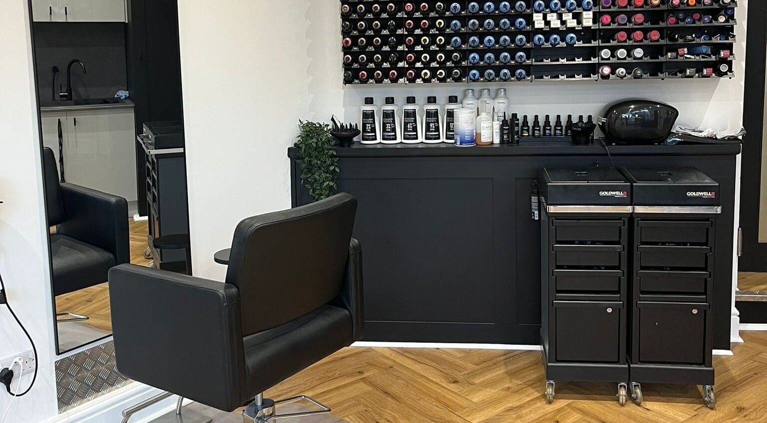 Modern salon interior at Andrew David Hair, Lymington, England, GB, featuring styling chairs and hair color display.