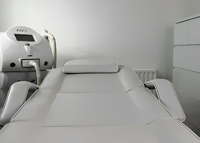 Modern treatment room at Vintage, Salford, England, GB featuring a white therapy chair and equipment.