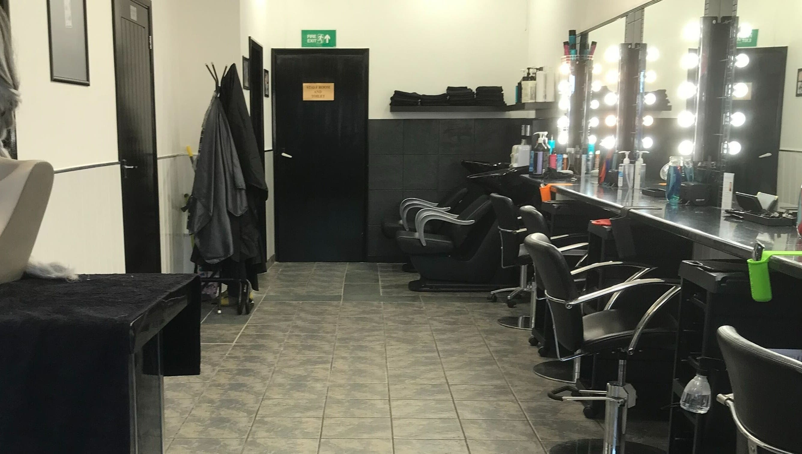 Modern and stylish salon interior at Hair and Body, Colchester, England, GB, featuring elegant styling chairs.