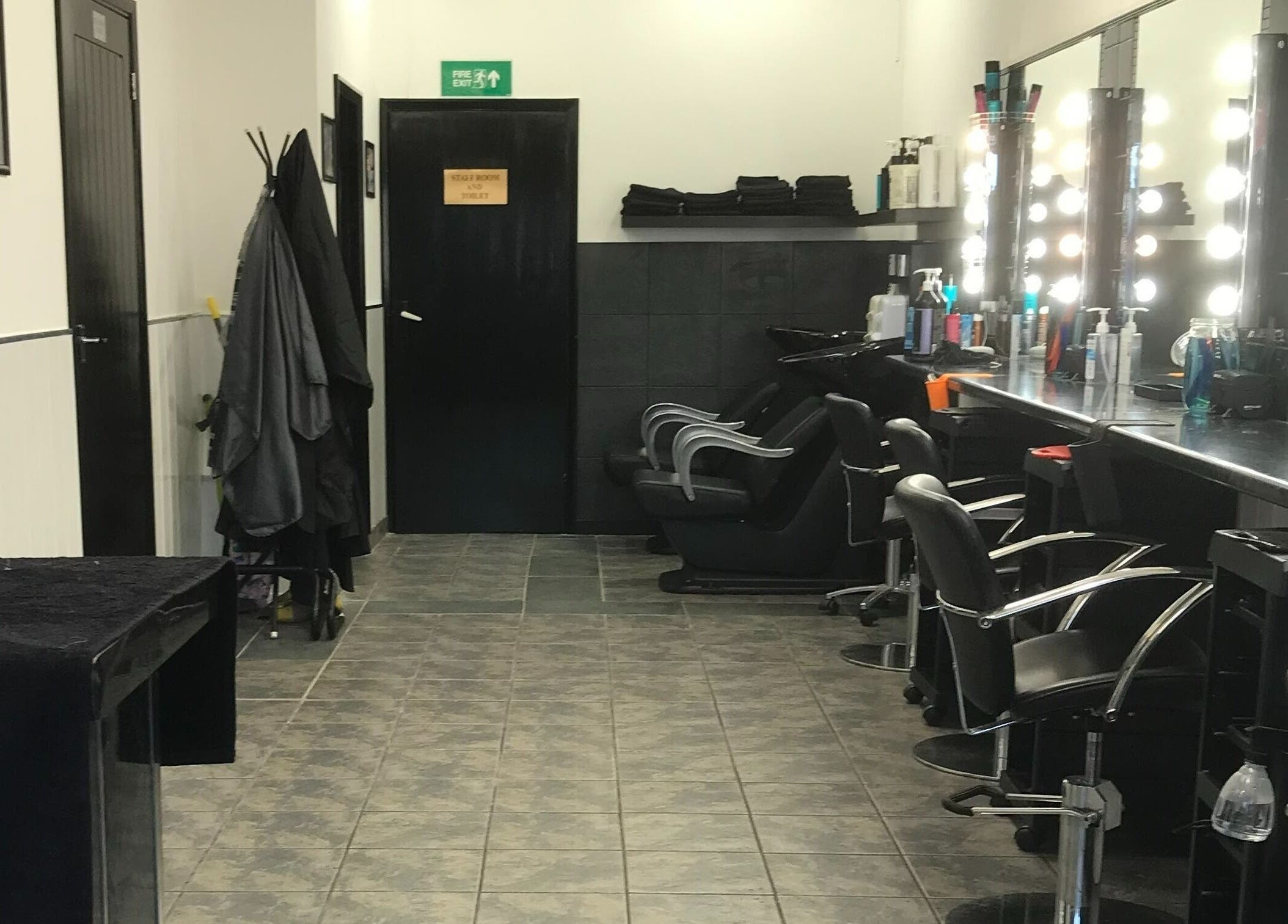 Modern and stylish salon interior at Hair and Body, Colchester, England, GB, featuring elegant styling chairs.