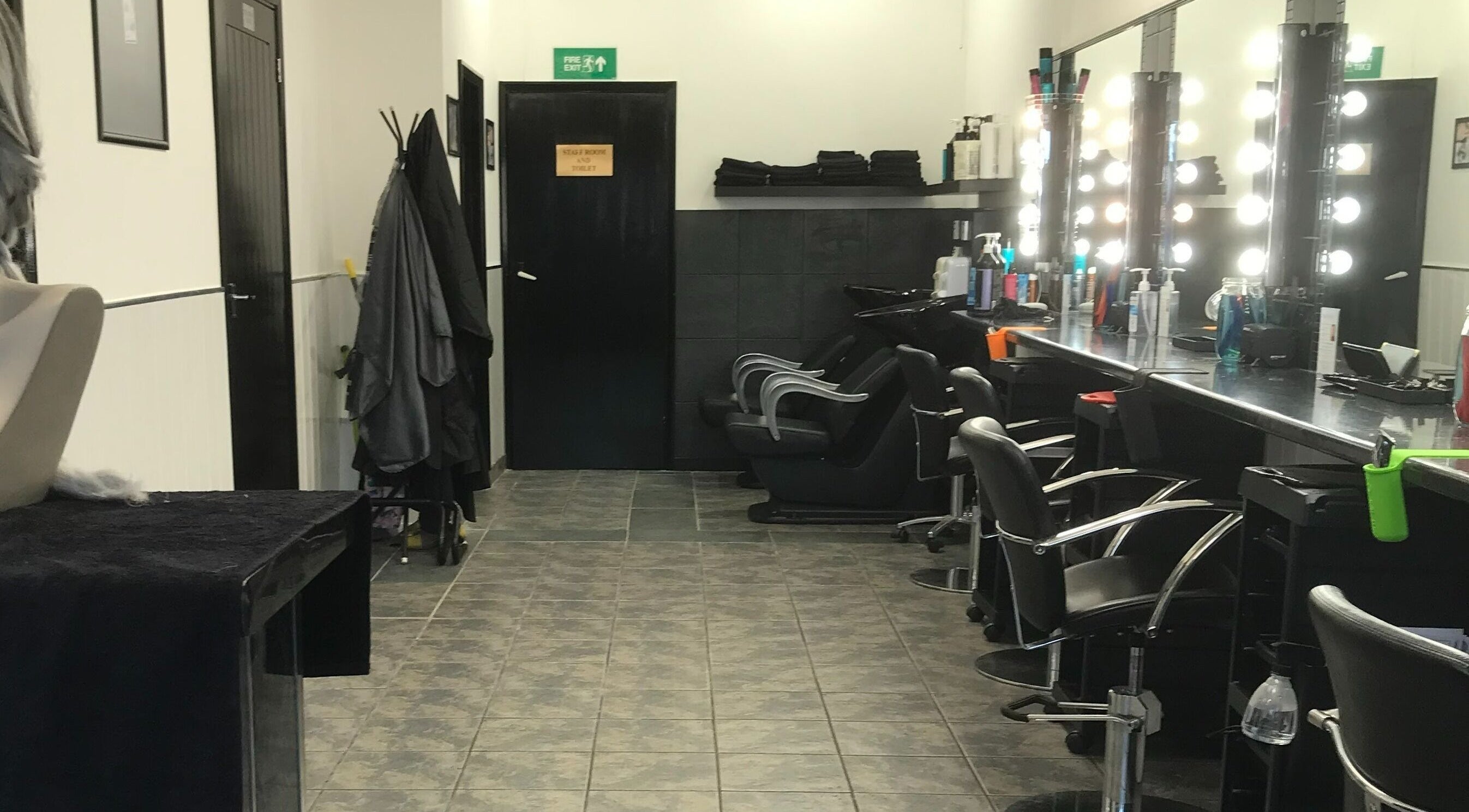 Modern and stylish salon interior at Hair and Body, Colchester, England, GB, featuring elegant styling chairs.