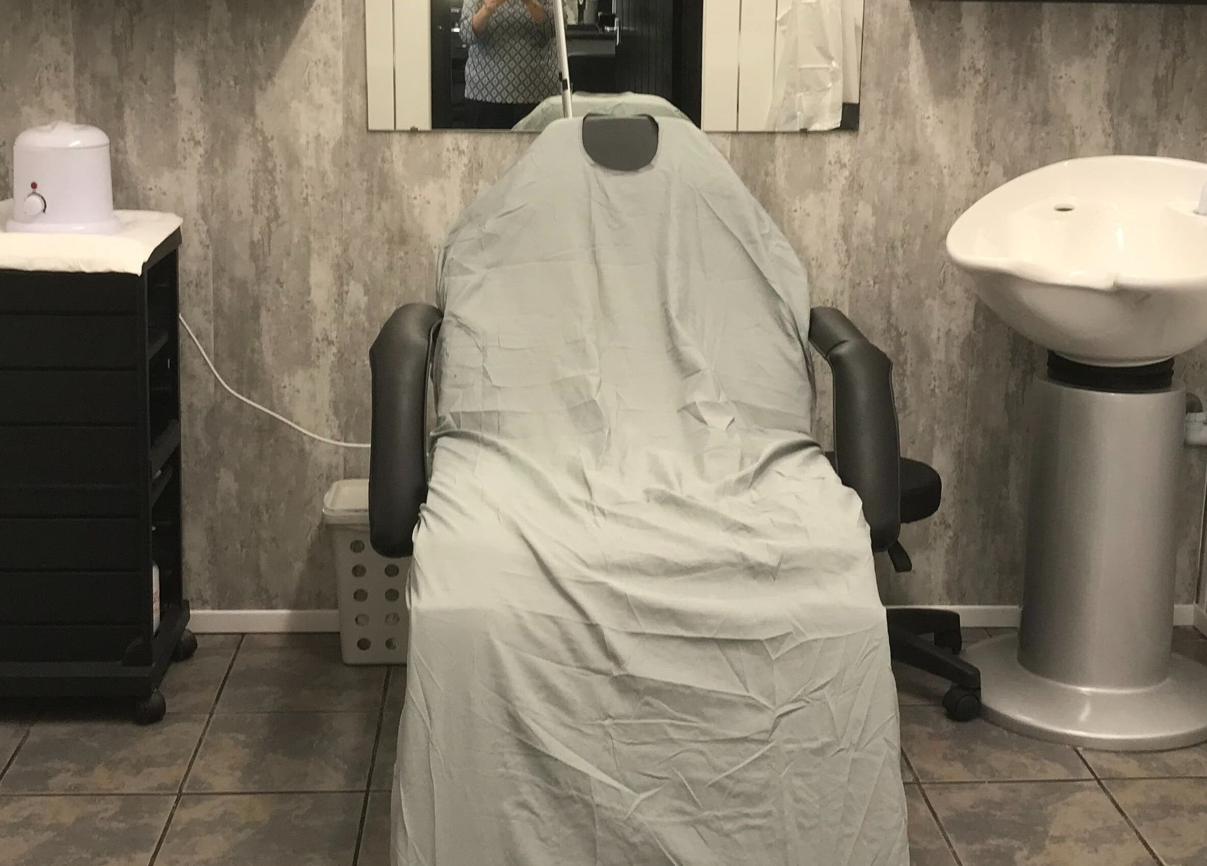 Treatment chair and sink at Hair and Body, Colchester, England, GB offering a calm stylistic setup.