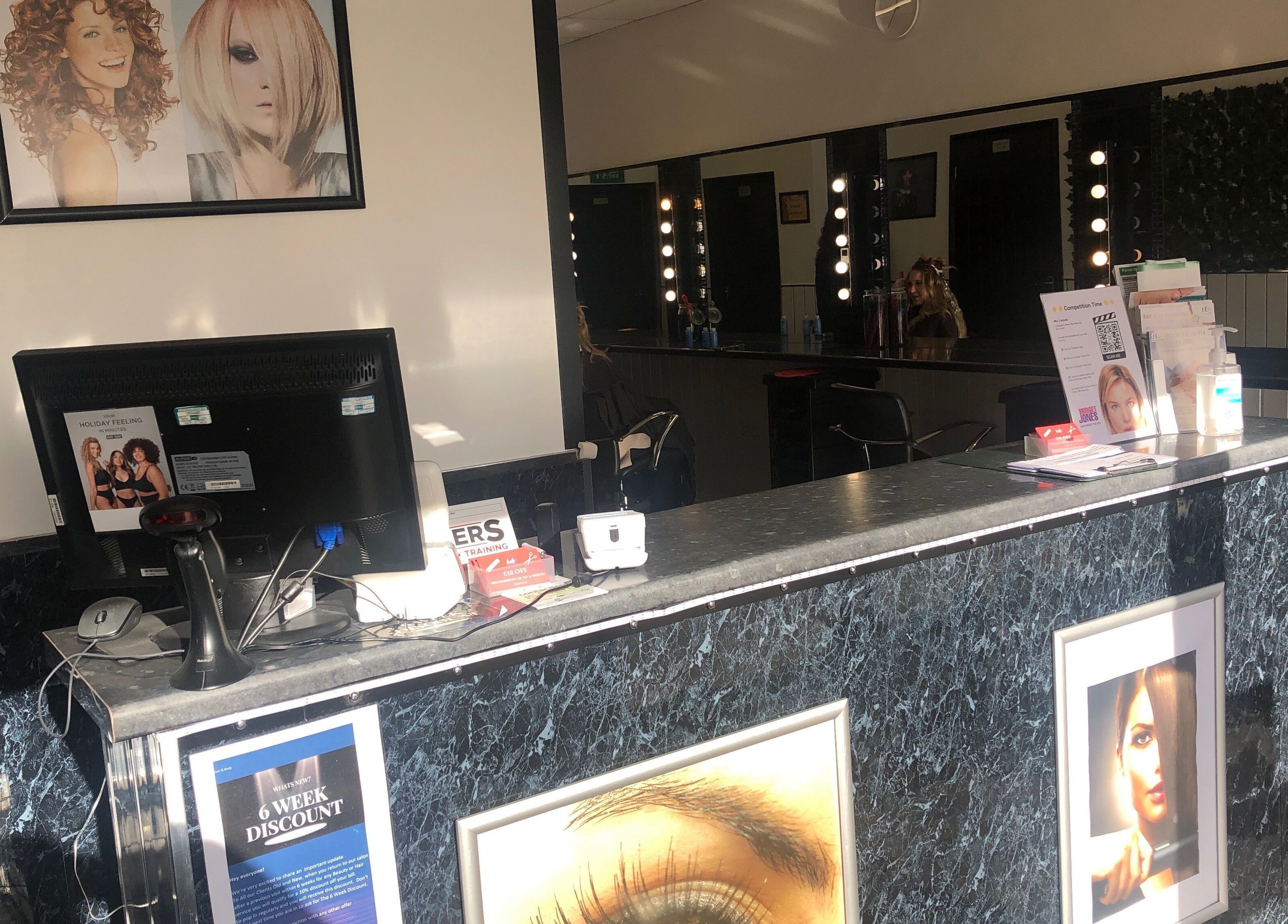 Reception area of Hair and Body in Colchester, England, GB, featuring modern decor and beauty displays.