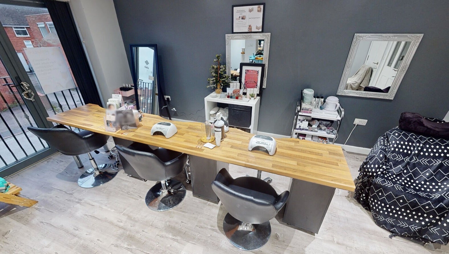 Modern nail station at The Boutique, Knowle, England, GB with sleek chairs and manicure tools.