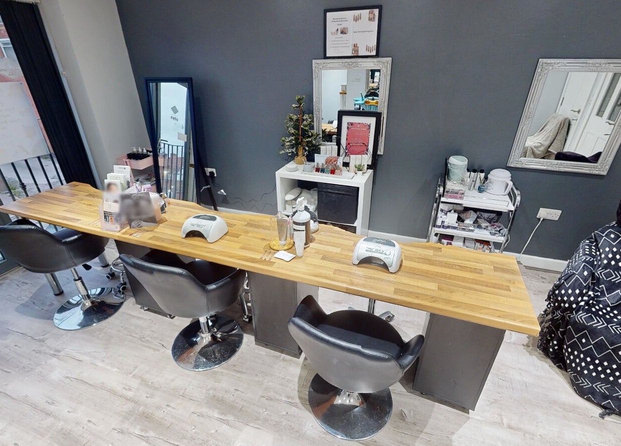 Modern nail station at The Boutique, Knowle, England, GB with sleek chairs and manicure tools.