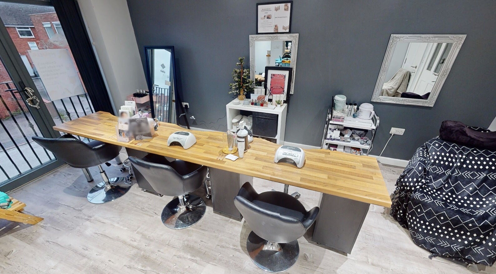 Modern nail station at The Boutique, Knowle, England, GB with sleek chairs and manicure tools.