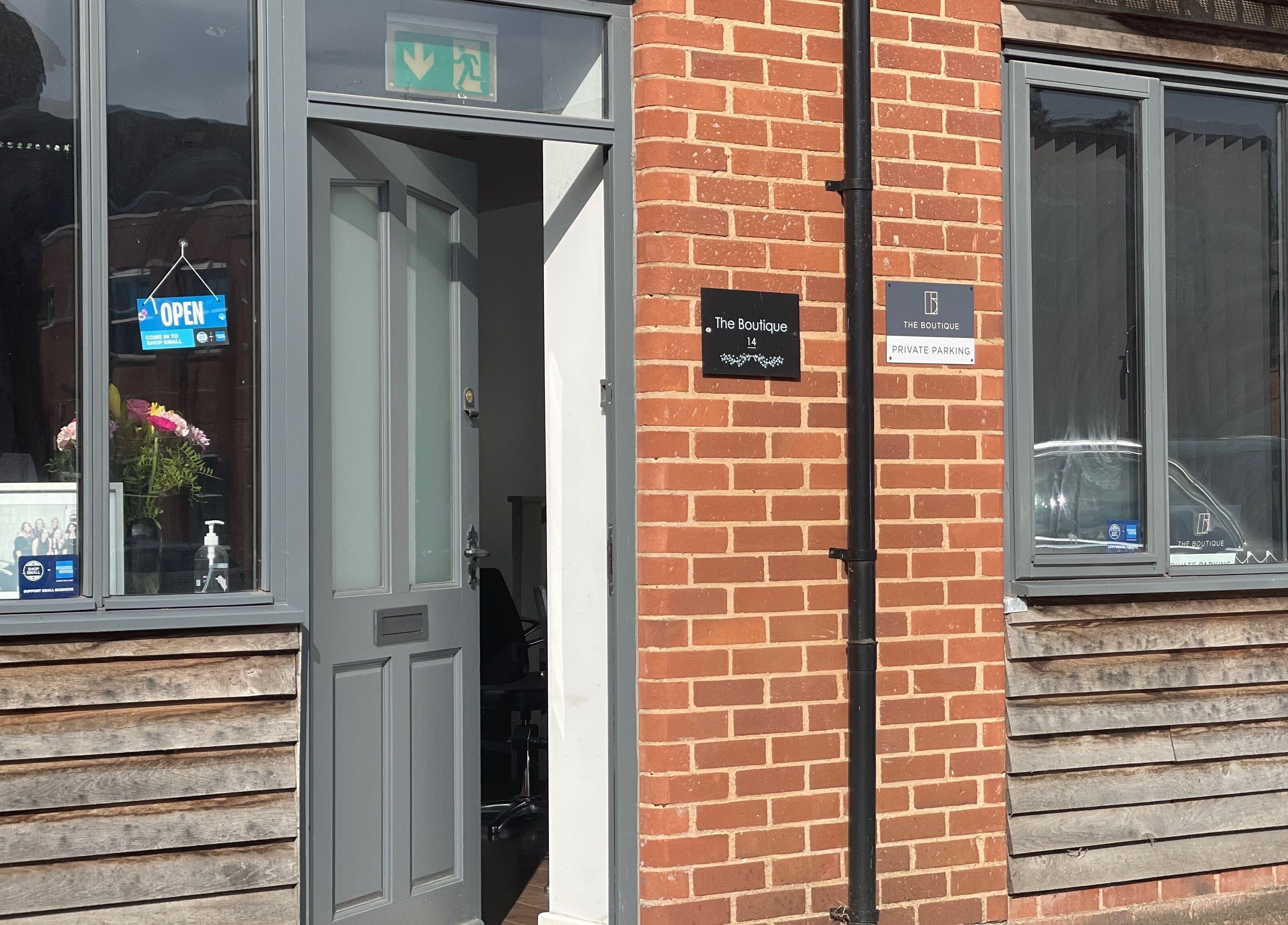 The Boutique entrance in Knowle, England, GB, featuring a welcoming open sign and stylish decor.