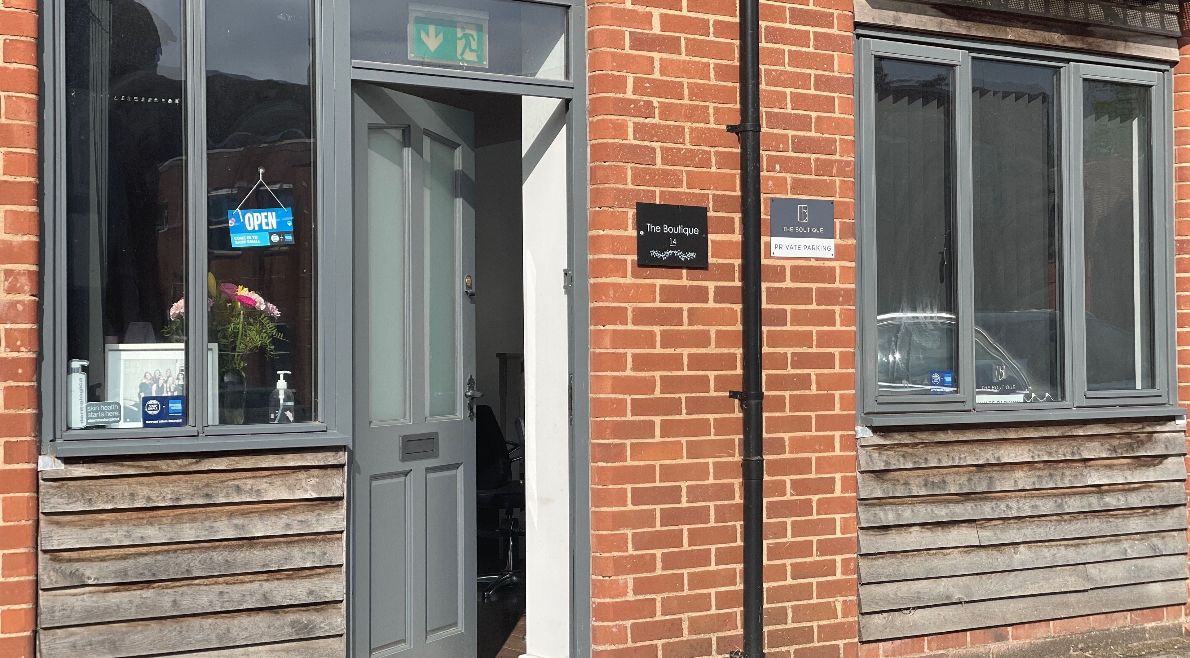 The Boutique entrance in Knowle, England, GB, featuring a welcoming open sign and stylish decor.