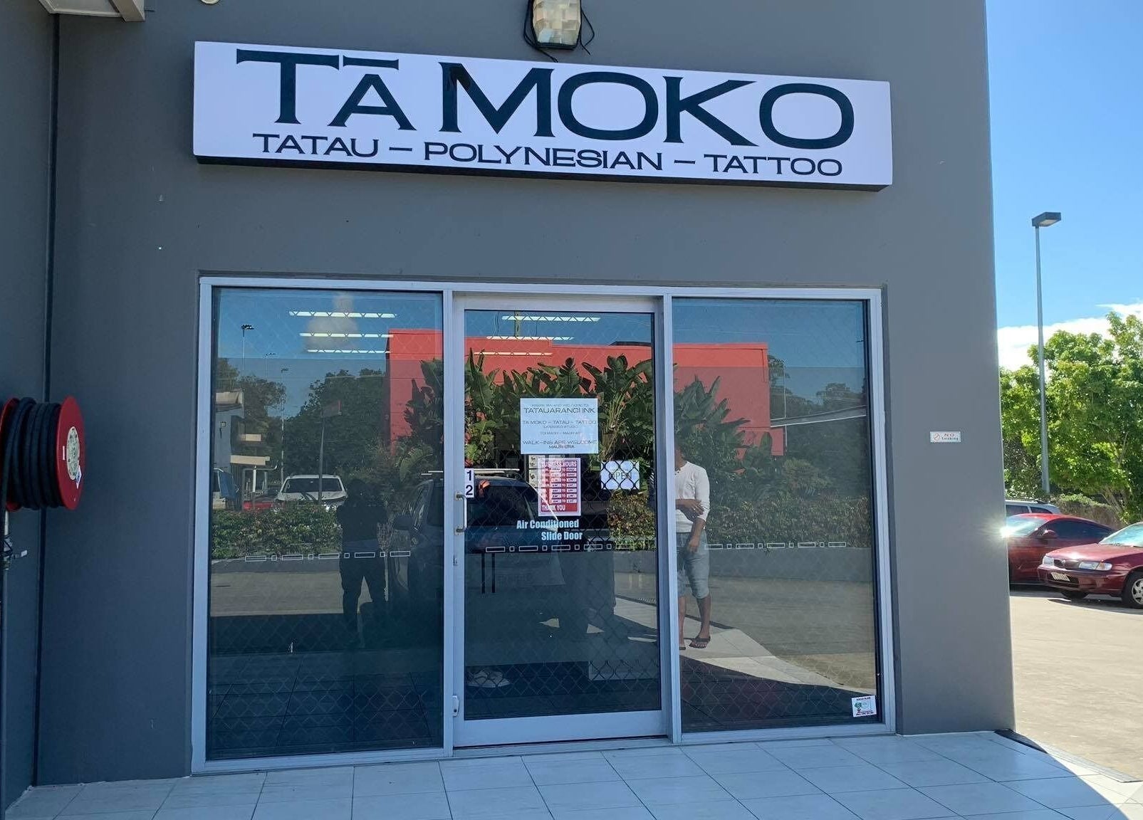 Entrance of Tatauarangi Ink tattoo studio in Helensvale, Queensland, AU with signage visible on the facade.