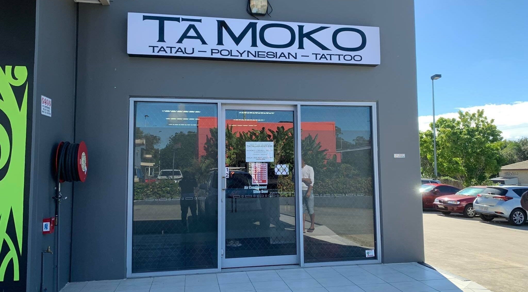 Entrance of Tatauarangi Ink tattoo studio in Helensvale, Queensland, AU with signage visible on the facade.