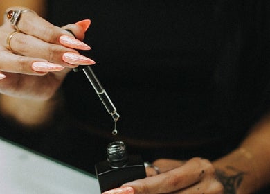 Close-up of nail oil application at So Nailz, Draper, Utah, US.