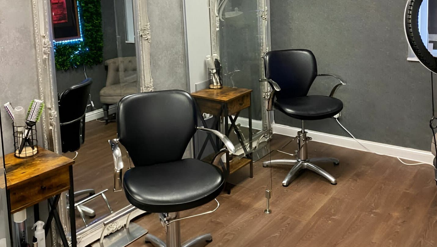 Modern salon chairs at Mirrors of Airdrie in Airdrie, Scotland, GB, showcasing sleek and professional styling setup.