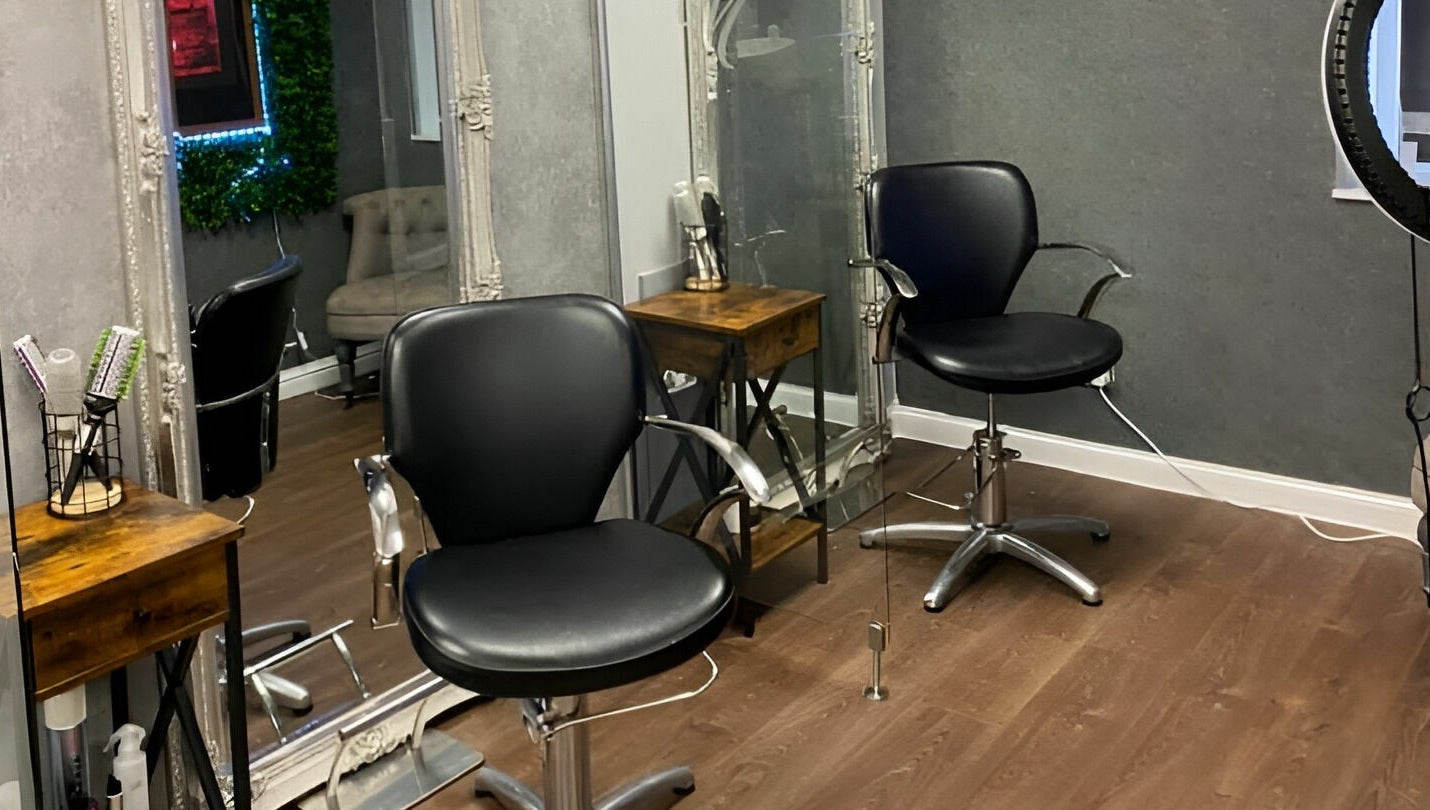 Modern salon chairs at Mirrors of Airdrie in Airdrie, Scotland, GB, showcasing sleek and professional styling setup.