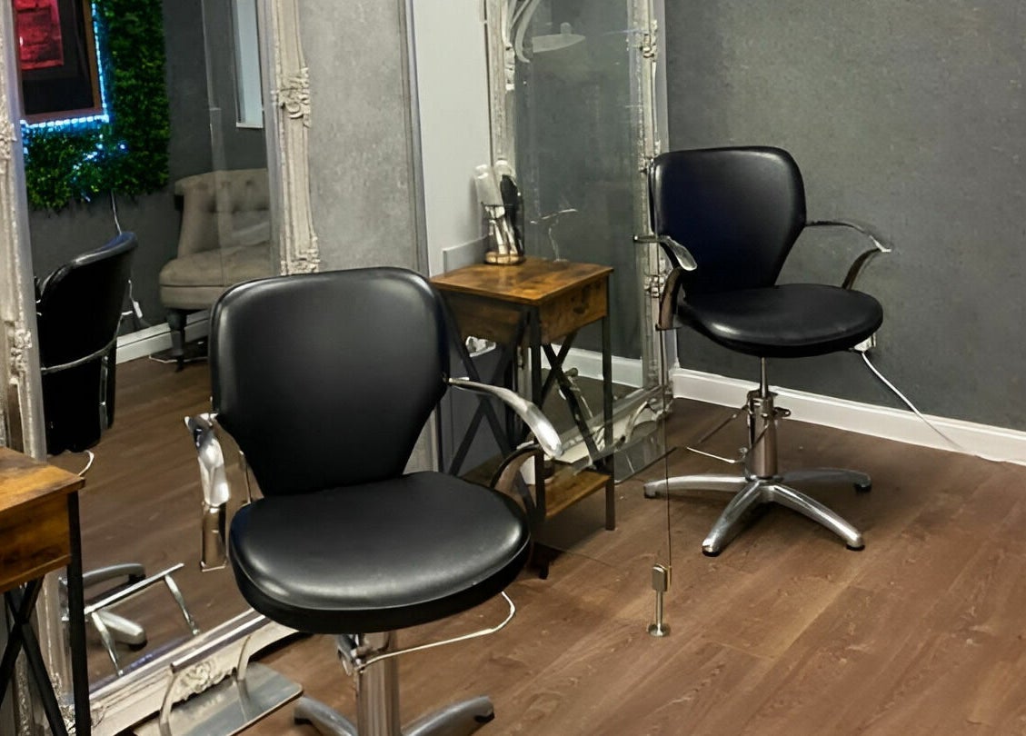 Modern salon chairs at Mirrors of Airdrie in Airdrie, Scotland, GB, showcasing sleek and professional styling setup.