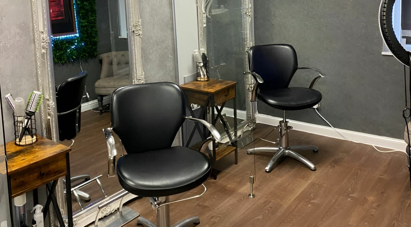 Modern salon chairs at Mirrors of Airdrie in Airdrie, Scotland, GB, showcasing sleek and professional styling setup.