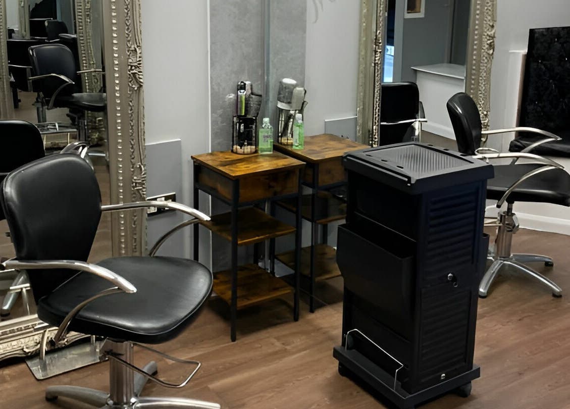 Modern salon interior at Mirrors of Airdrie, Airdrie, Scotland, GB with styling chairs and ornate mirrors.