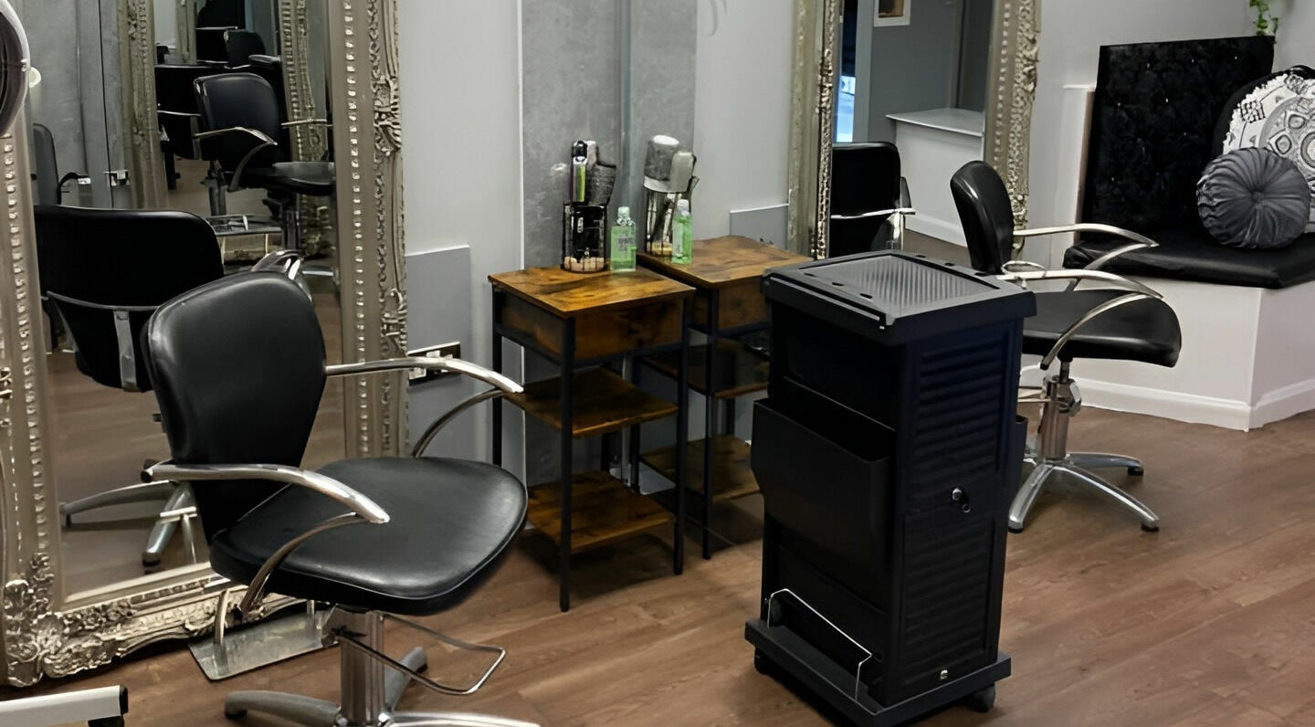 Modern salon interior at Mirrors of Airdrie, Airdrie, Scotland, GB with styling chairs and ornate mirrors.