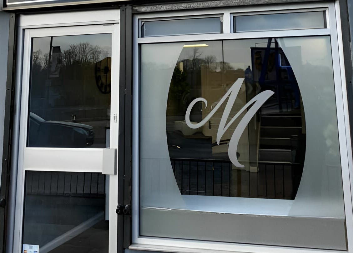 Front view of Mirrors of Airdrie entrance with logo on window, located in Airdrie, Scotland, GB.