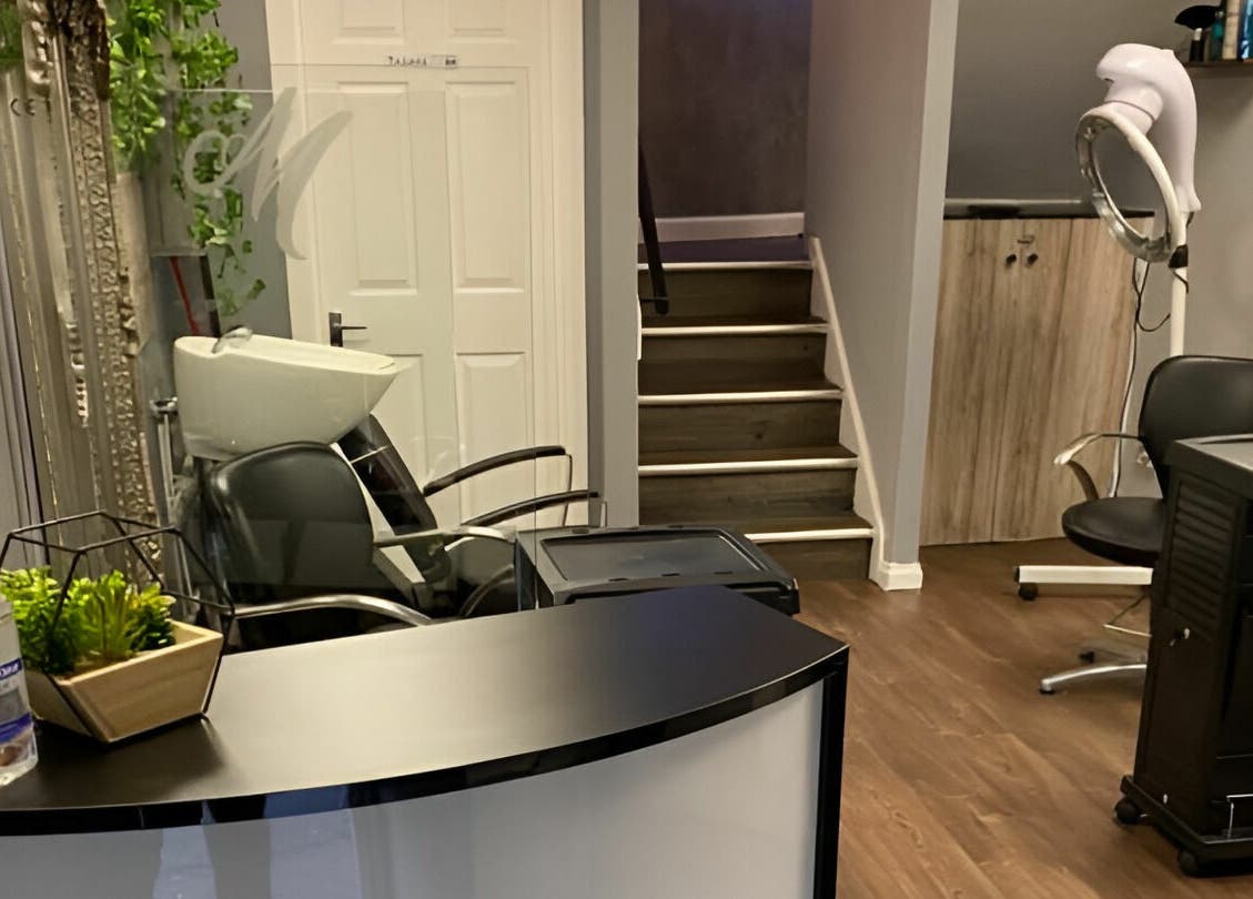 Chic salon interior at Mirrors of Airdrie, Airdrie, Scotland, GB showcasing stylish decor and hairdressing chairs.