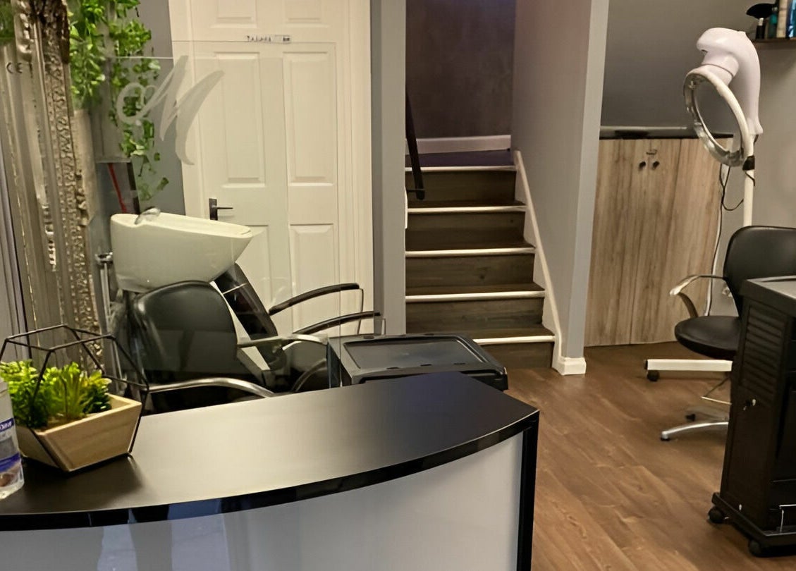 Chic salon interior at Mirrors of Airdrie, Airdrie, Scotland, GB showcasing stylish decor and hairdressing chairs.