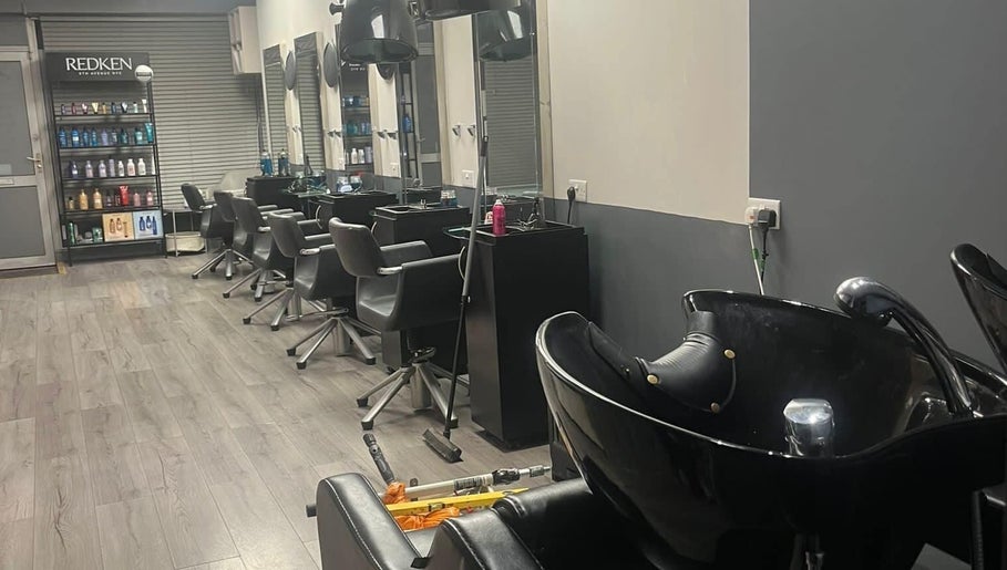 Modern salon setup at The Hair and Beauty Lounge, Crawley, England, GB featuring sleek chairs and wash stations.