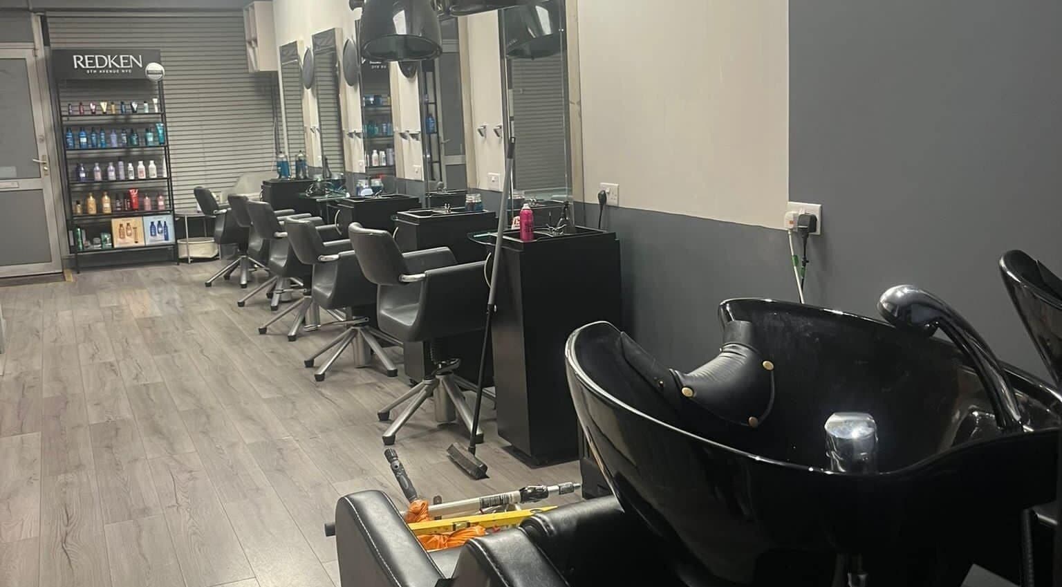 Modern salon setup at The Hair and Beauty Lounge, Crawley, England, GB featuring sleek chairs and wash stations.
