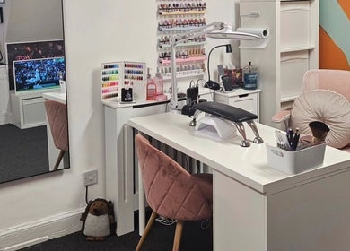 A stylish nail care station at Nova Nails, Glasgow, Scotland, GB featuring polish display and comfortable seating.