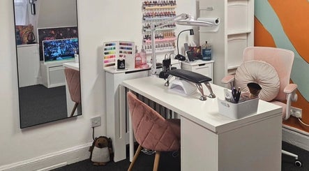 A stylish nail care station at Nova Nails, Glasgow, Scotland, GB featuring polish display and comfortable seating.