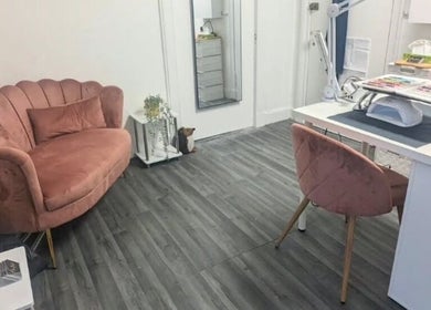 Elegant interior of Nova Nails with pink sofa and nail station, Glasgow, Scotland, GB.