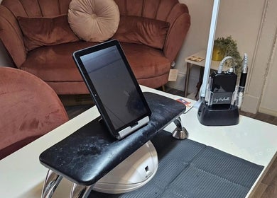 Modern nail station with equipment at Nova Nails in Glasgow, Scotland, GB, featuring cozy seating.