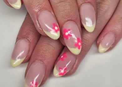 Elegant floral nail art by Nova Nails, Glasgow, Scotland, GB. Pale yellow tips with pink flowers on manicured nails.
