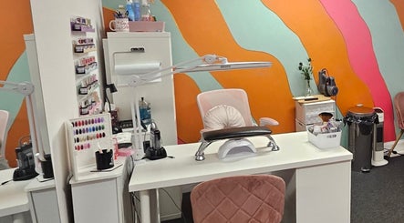 Bright, stylish nail station at Nova Nails in Glasgow, Scotland, GB, featuring vibrant wall art and trendy decor.
