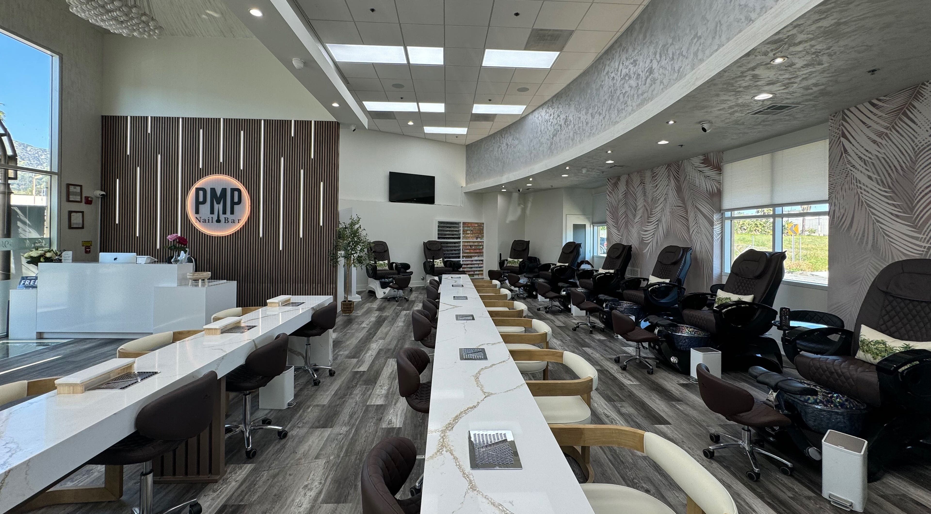 Modern interior of Polish Me Pretty Nail Bar in Burbank, California with chic nail stations and pedicure chairs.