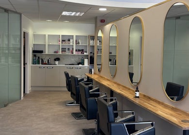 Chic interior of Kalon Hair Studio in Edinburgh, Scotland, GB showcasing stylish salon chairs and mirrors.