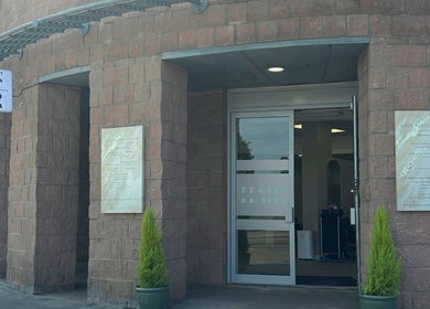 Entrance to Kalon Hair Studio, Edinburgh, Scotland, GB with brick facade and welcoming signage.