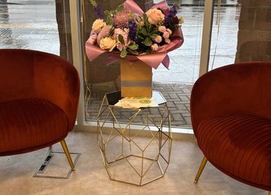 Elegant seating area with floral centerpiece at Kalon Hair Studio, Edinburgh, Scotland, GB.