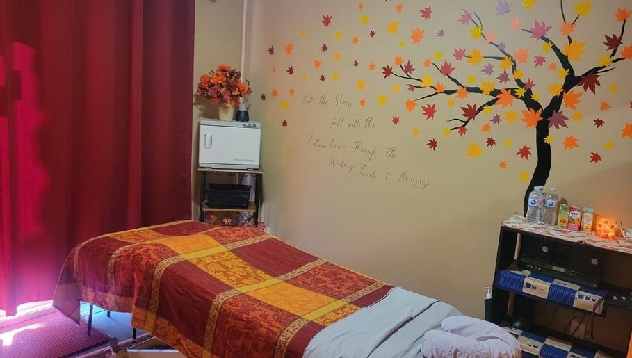 Cozy massage room at Cori's Healing Hands Massage in Edmonton, Alberta, CA with autumn-themed decor.