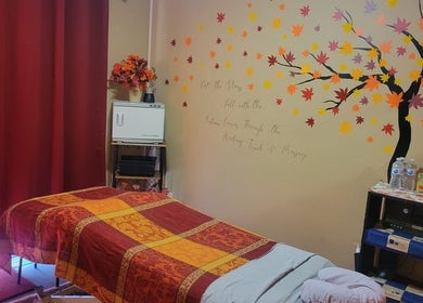 Cozy massage room at Cori's Healing Hands Massage in Edmonton, Alberta, CA with autumn-themed decor.
