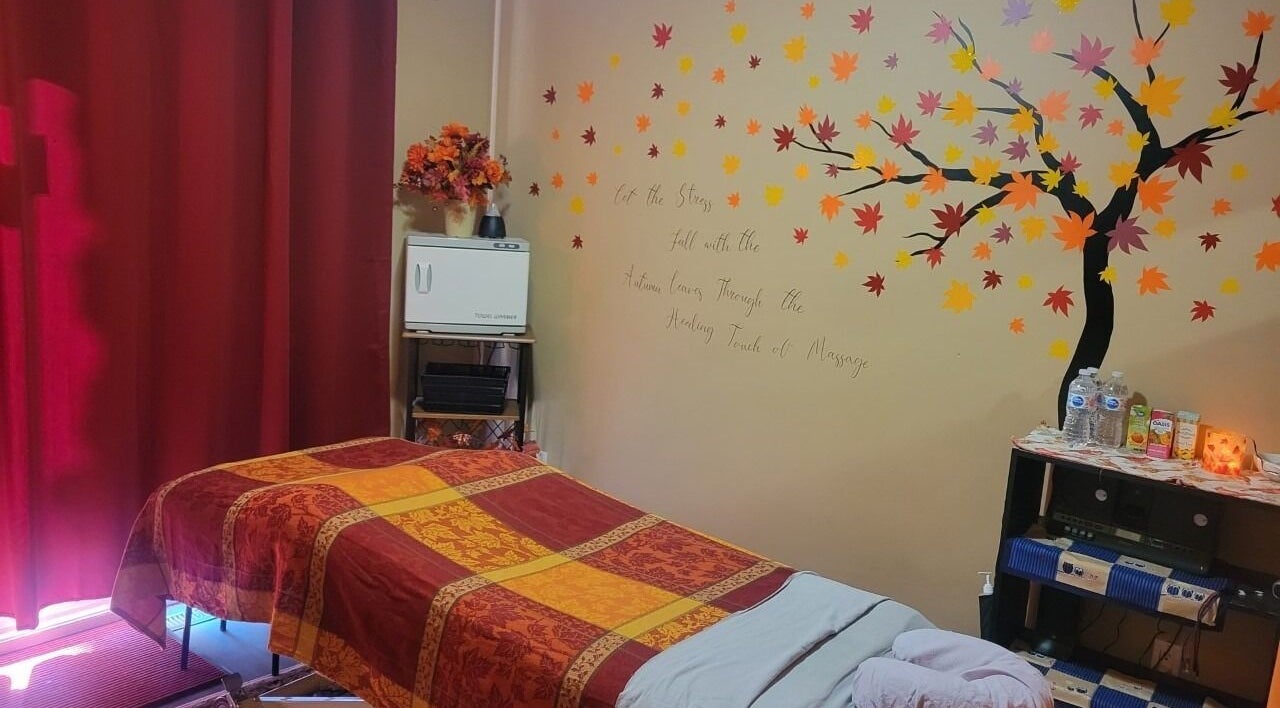 Cozy massage room at Cori's Healing Hands Massage in Edmonton, Alberta, CA with autumn-themed decor.