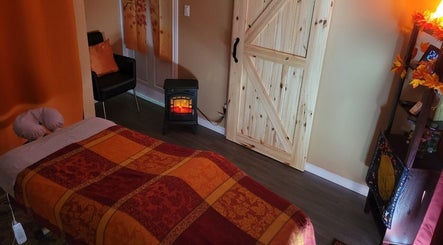 Cozy massage room at Cori's Healing Hands Massage, Edmonton, Alberta, CA with warm decor and soft lighting.