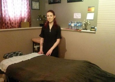 Massage therapist at Cori's Healing Hands Massage in Edmonton, Alberta, CA in a cozy treatment room.