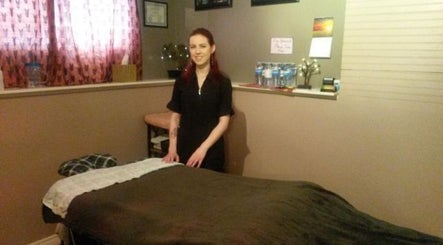 Massage therapist at Cori's Healing Hands Massage in Edmonton, Alberta, CA in a cozy treatment room.