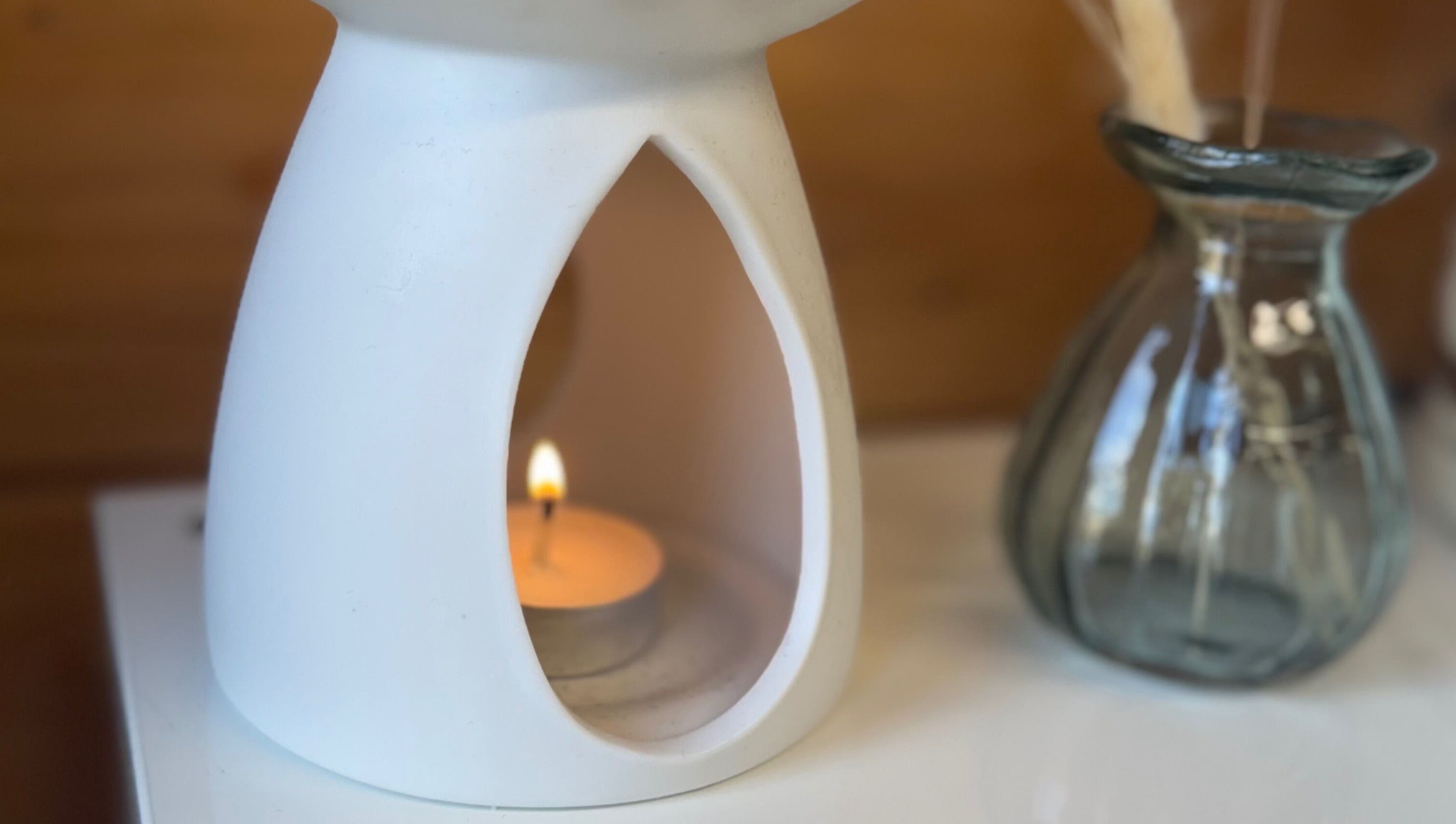 A soothing candle at Hygge Beauty Room, West Molesey, England, GB, enhancing relaxation ambiance.