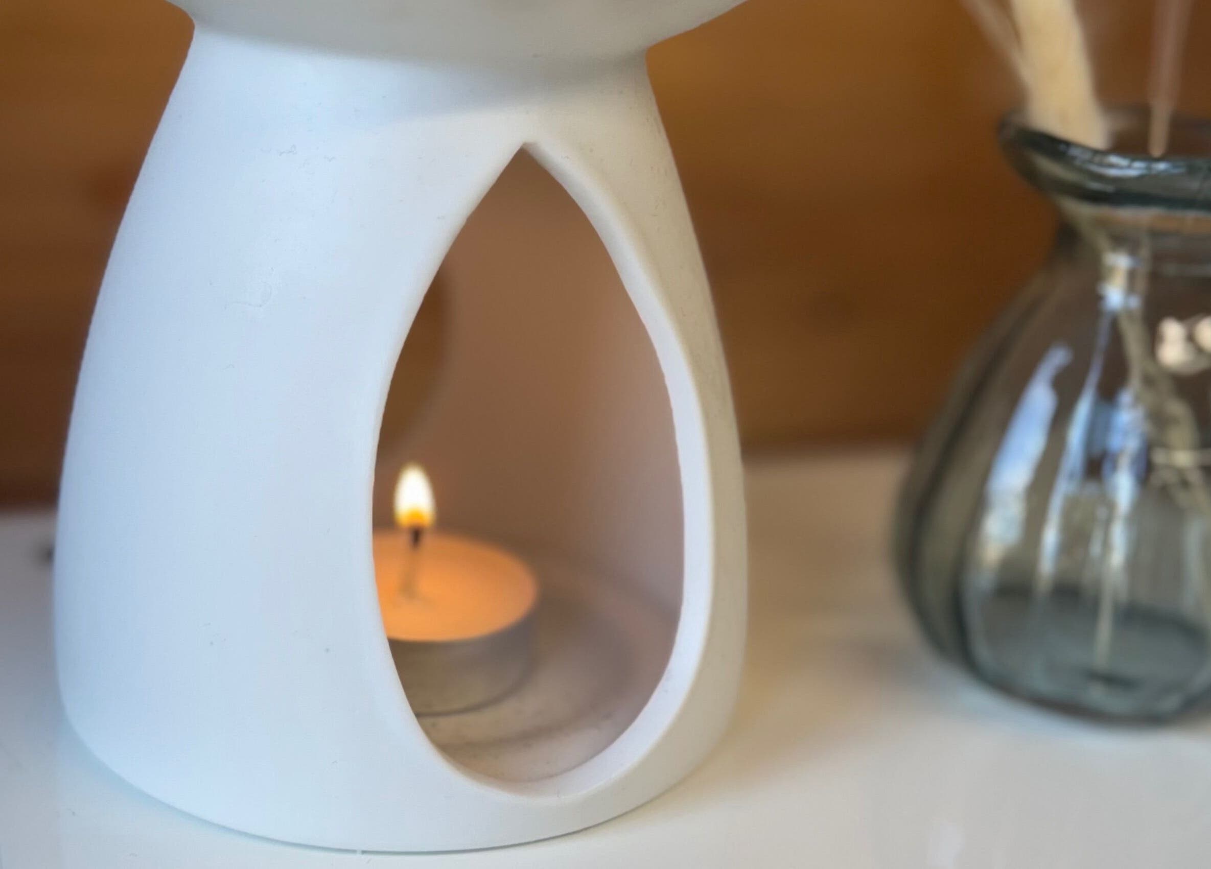 A soothing candle at Hygge Beauty Room, West Molesey, England, GB, enhancing relaxation ambiance.