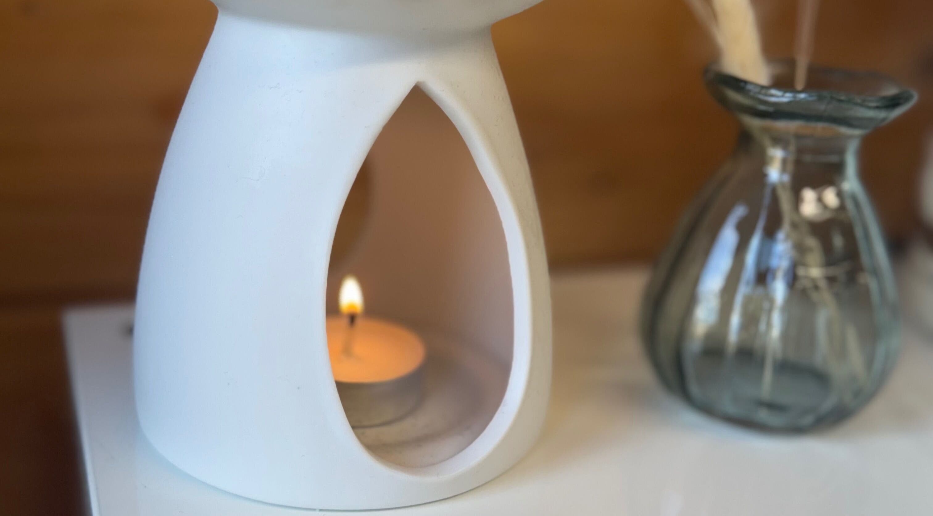 A soothing candle at Hygge Beauty Room, West Molesey, England, GB, enhancing relaxation ambiance.