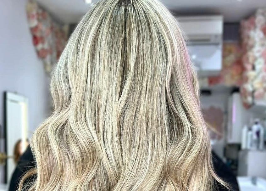Blonde wavy hair styled at AKai salon, London, England, GB, showcasing elegance and shine.
