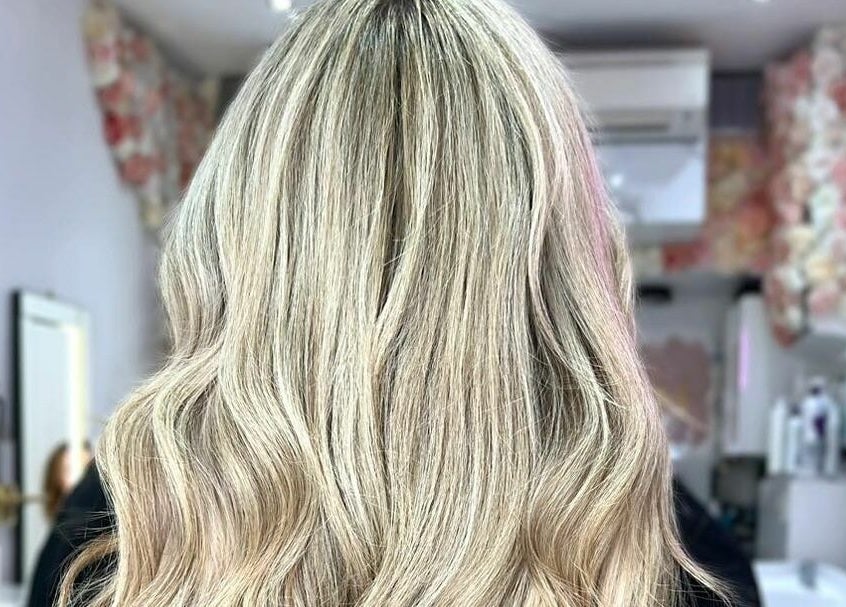 Blonde wavy hair styled at AKai salon, London, England, GB, showcasing elegance and shine.