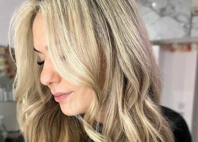 Close-up of stylish blonde curls at AKai, London, England, GB salon, highlighting luxurious hair care.