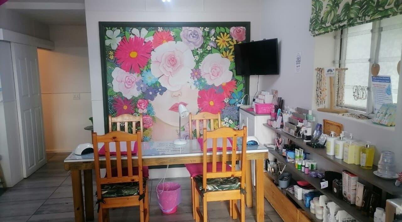 Pop in Beauty Bar, Saint Francis Bay, ZA: vibrant floral mural and cozy setup for beauty treatments.